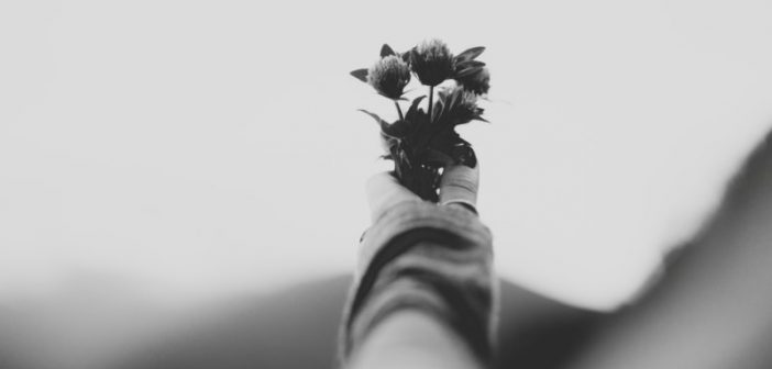 a person holding flowers to symbolize death