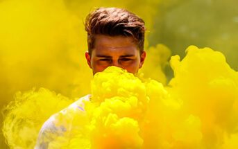 man surrounded by yellow smoke