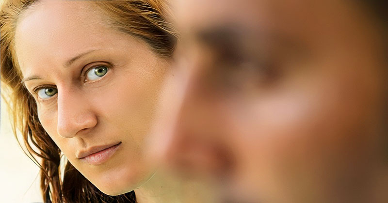 woman staring at partner in foreground illustrating boredom in a relationship