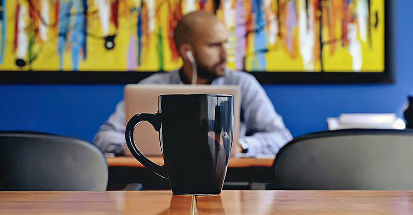 man with laptop and headphones - concept of working with social anxiety