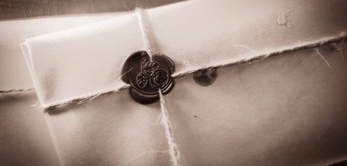 black and white photo of letter sealed in an envelope with string and wax