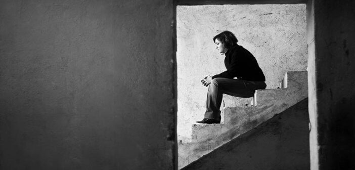 young woman sitting on steps facing adversity in life