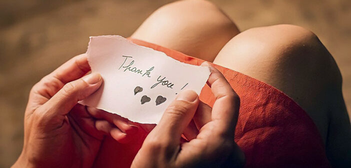 woman holding a thank you note