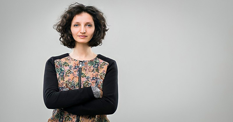 confident looking woman with arms crossed to show she is standing up for herself