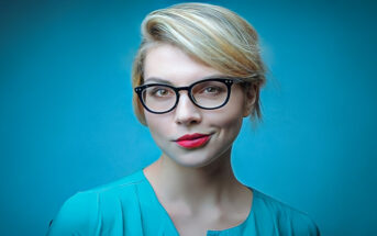 young blonde woman looking proud of herself