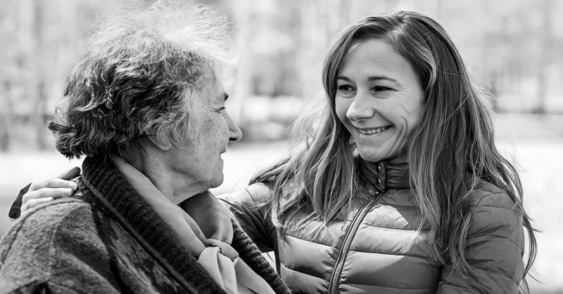 young woman showing respect to older woman