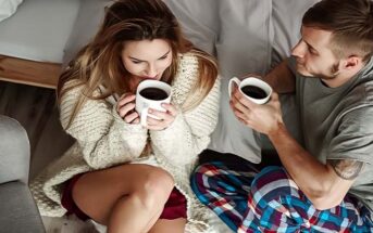 young couple drinking coffee on a couch illustrating loyalty in relationships