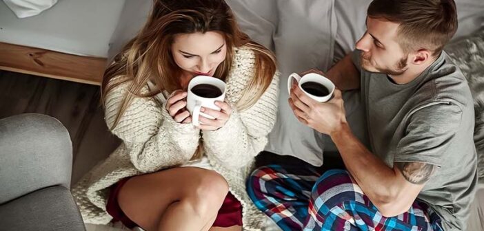 young couple drinking coffee on a couch illustrating loyalty in relationships