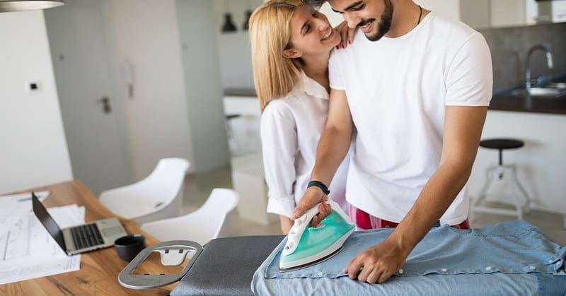 young couple in love doing ironing together