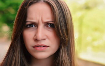 young woman with frown on her face signifying her negative outlook on life