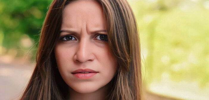 young woman with frown on her face signifying her negative outlook on life