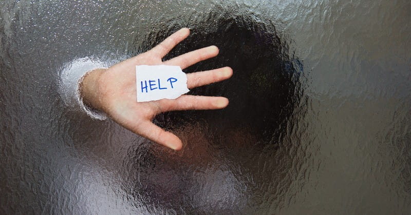 young woman behind frosted glass asking for help