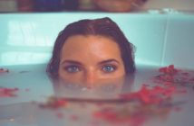 young empath woman submerged in bath