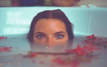 young empath woman submerged in bath