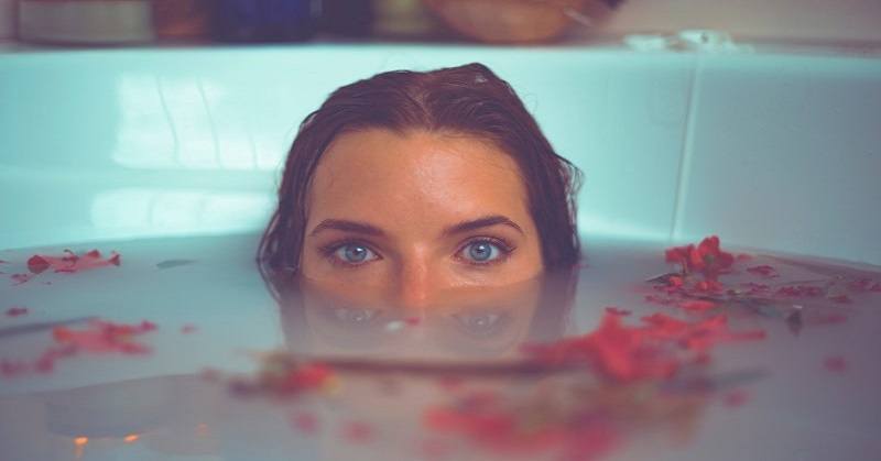 young empath woman submerged in bath