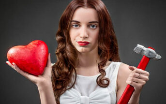 woman holding heart and hammer illustrating her relationship deal breakers