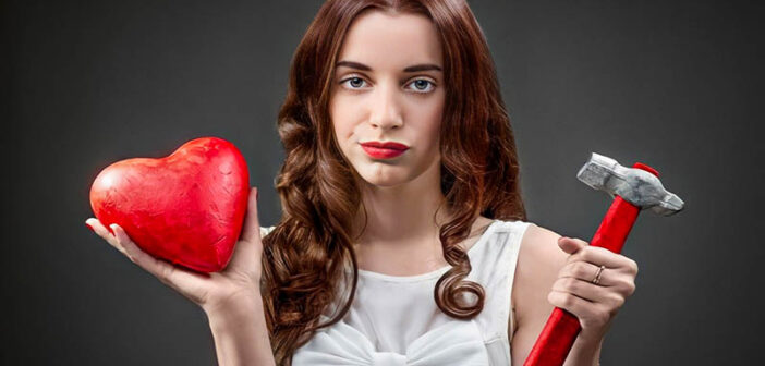 woman holding heart and hammer illustrating her relationship deal breakers