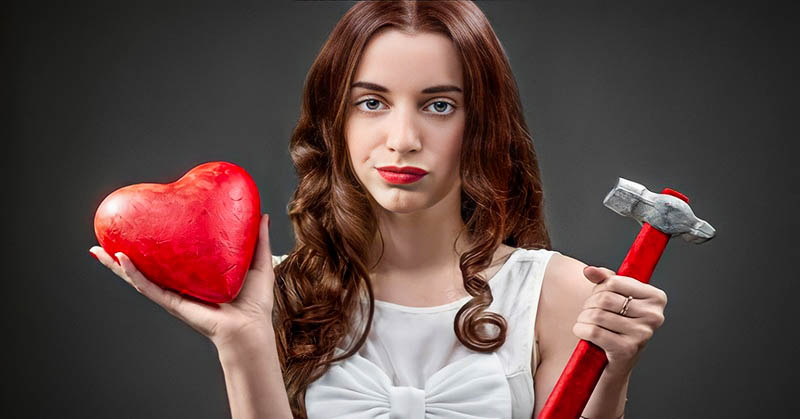 woman holding heart and hammer illustrating her relationship deal breakers