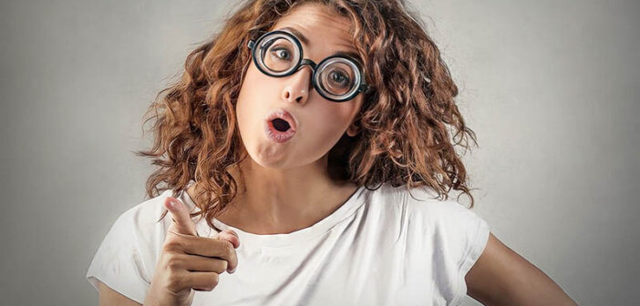 young woman with glasses pointing the finger, blaming others for her problems