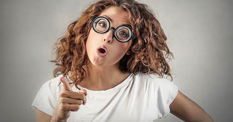 young woman with glasses pointing the finger, blaming others for her problems