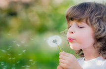 empath child blowing dandelion