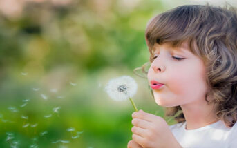 empath child blowing dandelion