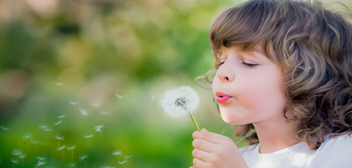 empath child blowing dandelion
