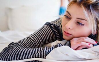 teenage girl laying on bed wanting to get over her crush