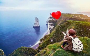 girl on cliff holding heart balloon illustrating that she's never been in a relationship or in love before