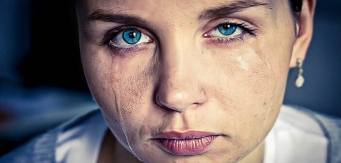 closeup of crying woman with tears running down her face