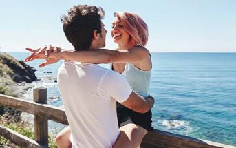 young couple smiling with ocean in the background illustrating infatuation versus love