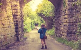 woman with map walking down country path illustrating trying to find yourself