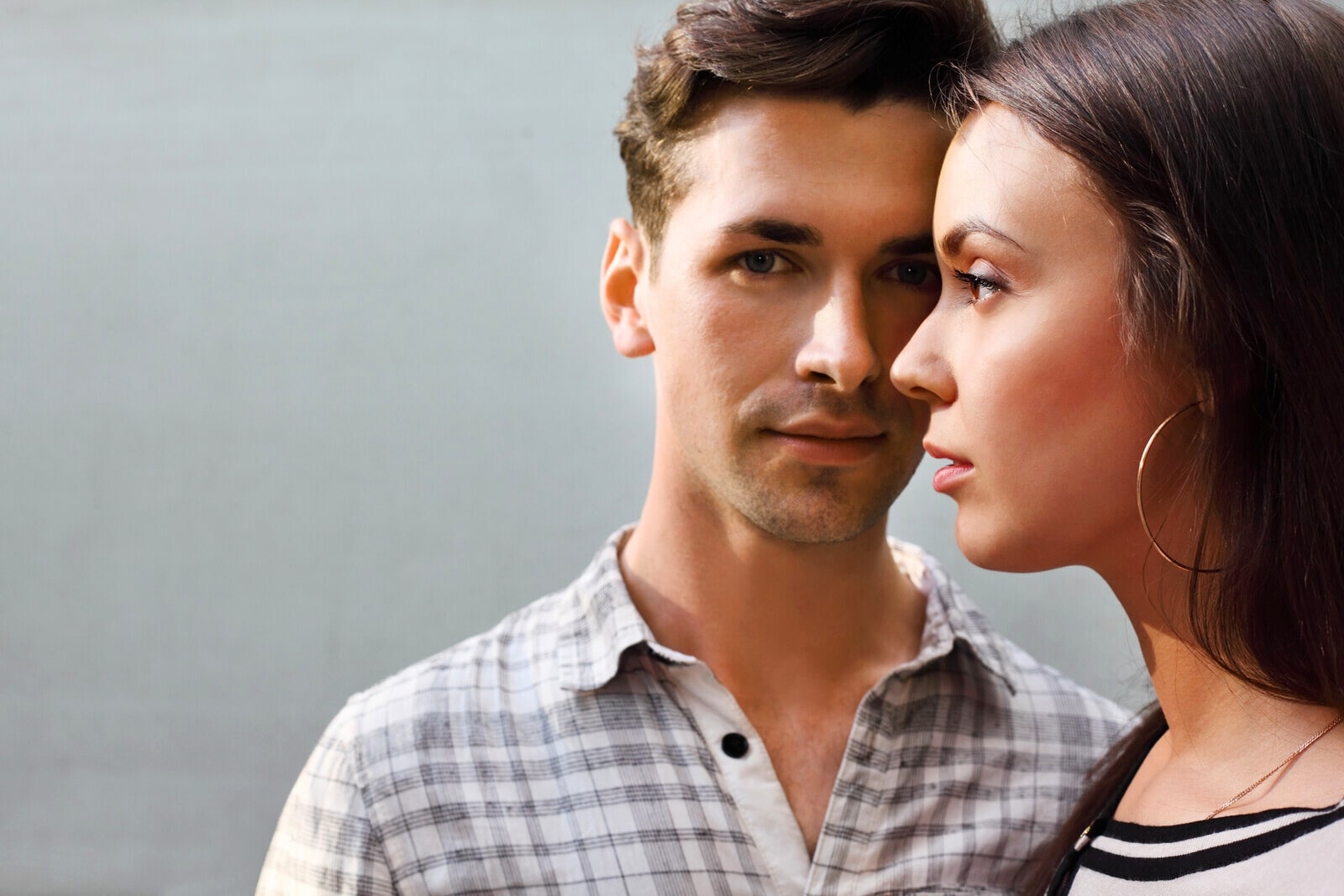 man and woman standing at right angles to one another