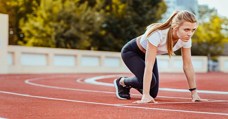 female runner under starters orders illustrating motivation