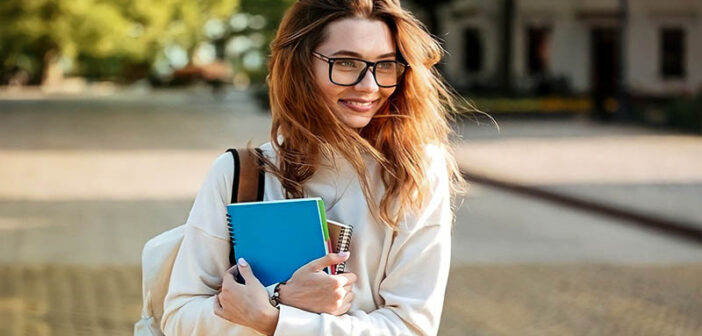 young woman with glasses holding books illustrating a reserved person