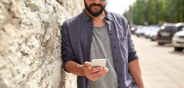 young man on phone texting a date