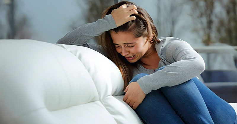young woman experiencing great emotional pain after a breakup