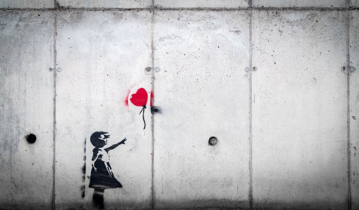 graffiti artwork of girl losing heart balloon 