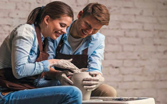 man and woman doing pottery together illustrating hobbies for couples
