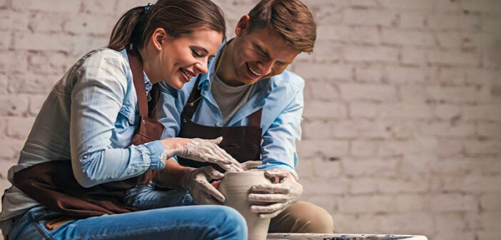 man and woman doing pottery together illustrating hobbies for couples