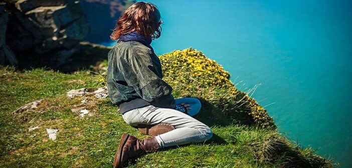 woman on clifftop thinking about her priorities in life