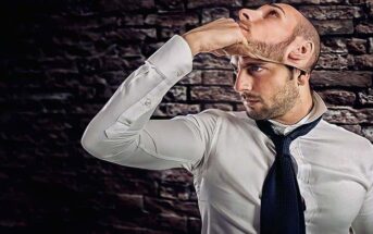 man lifting off mask to reveal face illustrating untrustworthy person