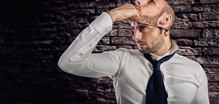 man lifting off mask to reveal face illustrating untrustworthy person
