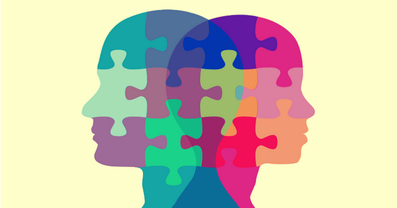 illustration of two heads overlapping as jigsaw pieces - concept of intellectual compatibility