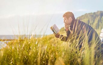 a man reading book alone in nature illustrating the concept of giving him space