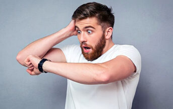shocked man looking at watch to illustrate the importance of being on time