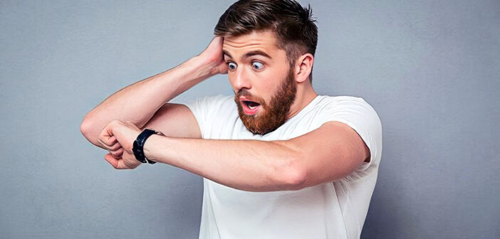 shocked man looking at watch to illustrate the importance of being on time