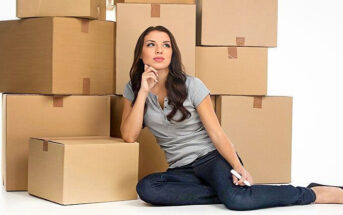 woman sitting in front of lots of boxes - illustrating the concept of compartmentalizing emotions