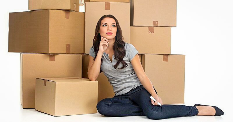 woman sitting in front of lots of boxes - illustrating the concept of compartmentalizing emotions