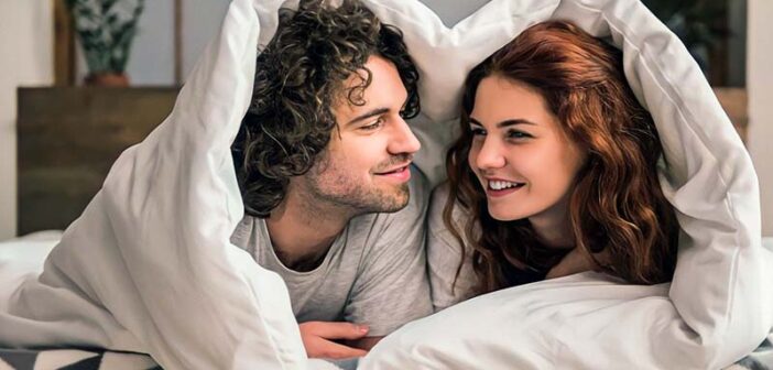 couple in bed asking each other questions
